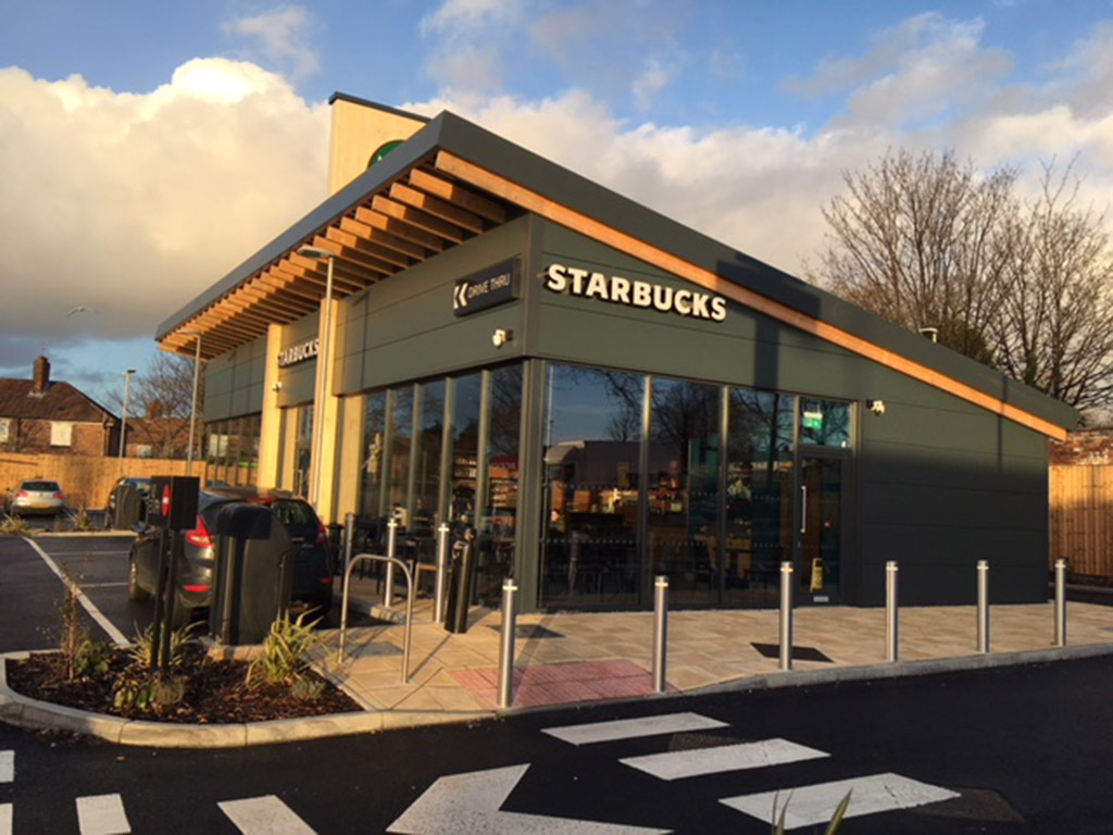 diagonal view of a spacious Starbucks cafe at sunset